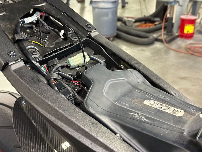 Rear of bare fuel tank cleared from seat tray