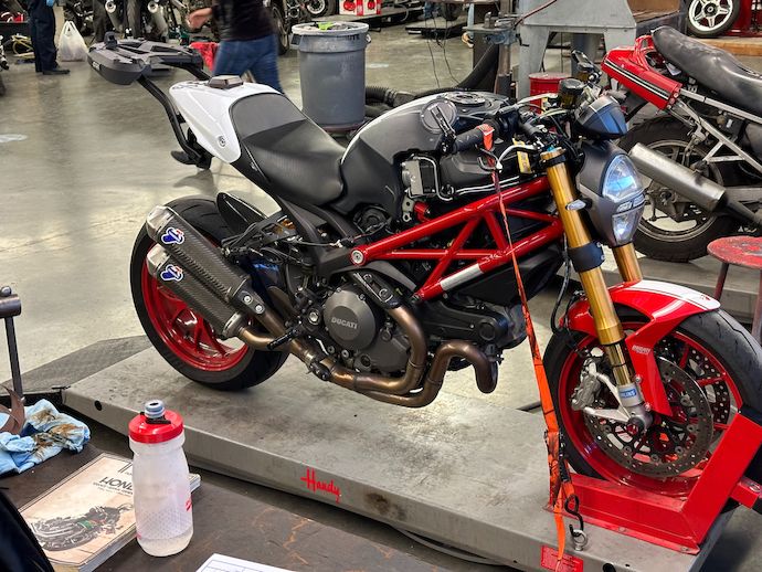 Monster on lowered work stand, strapped down