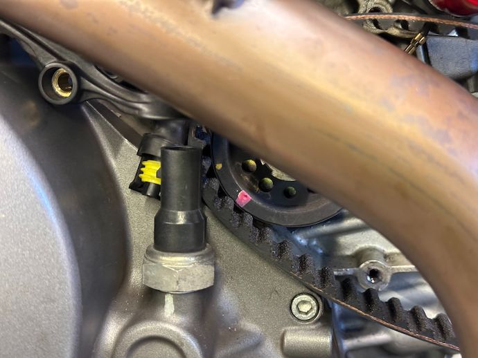 Crankshaft timing pulley with new timing belt partially installed