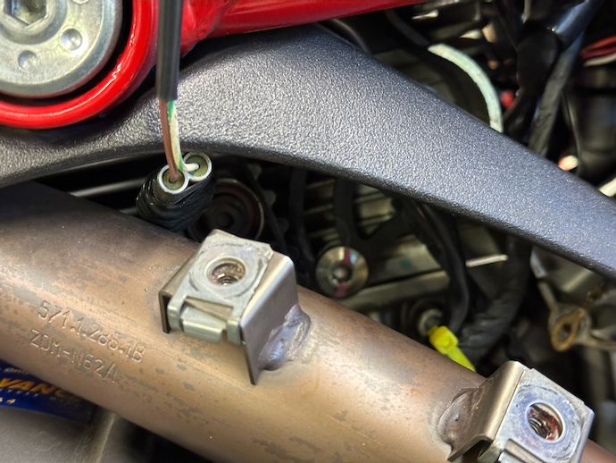 Rear cylinder header with heat shield mounting nuts