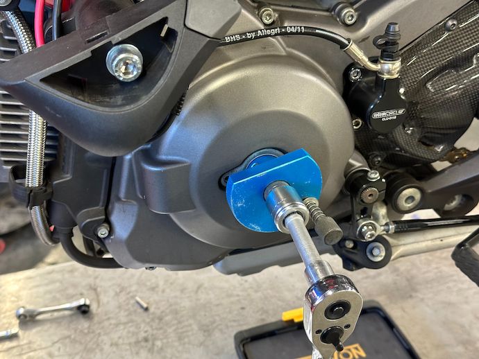 Demonstration of ratchet with extension and hex socket on crankshaft turning tool