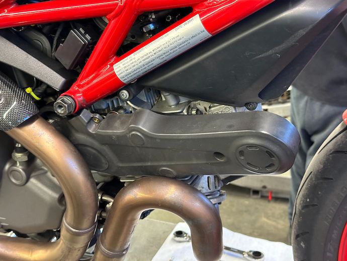 Front cylinder timing belt cover jammed against exhaust headers